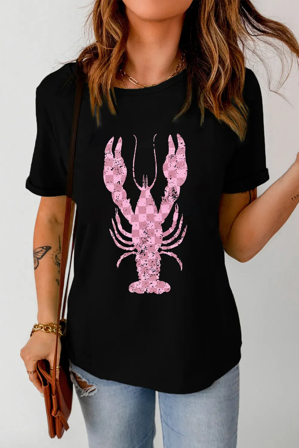 Black t-shirt with distressed pink checkered lobster graphic and short sleeves.