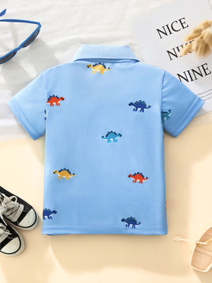 Light blue toddler polo shirt with colorful dinosaur print, short sleeves, and collar.