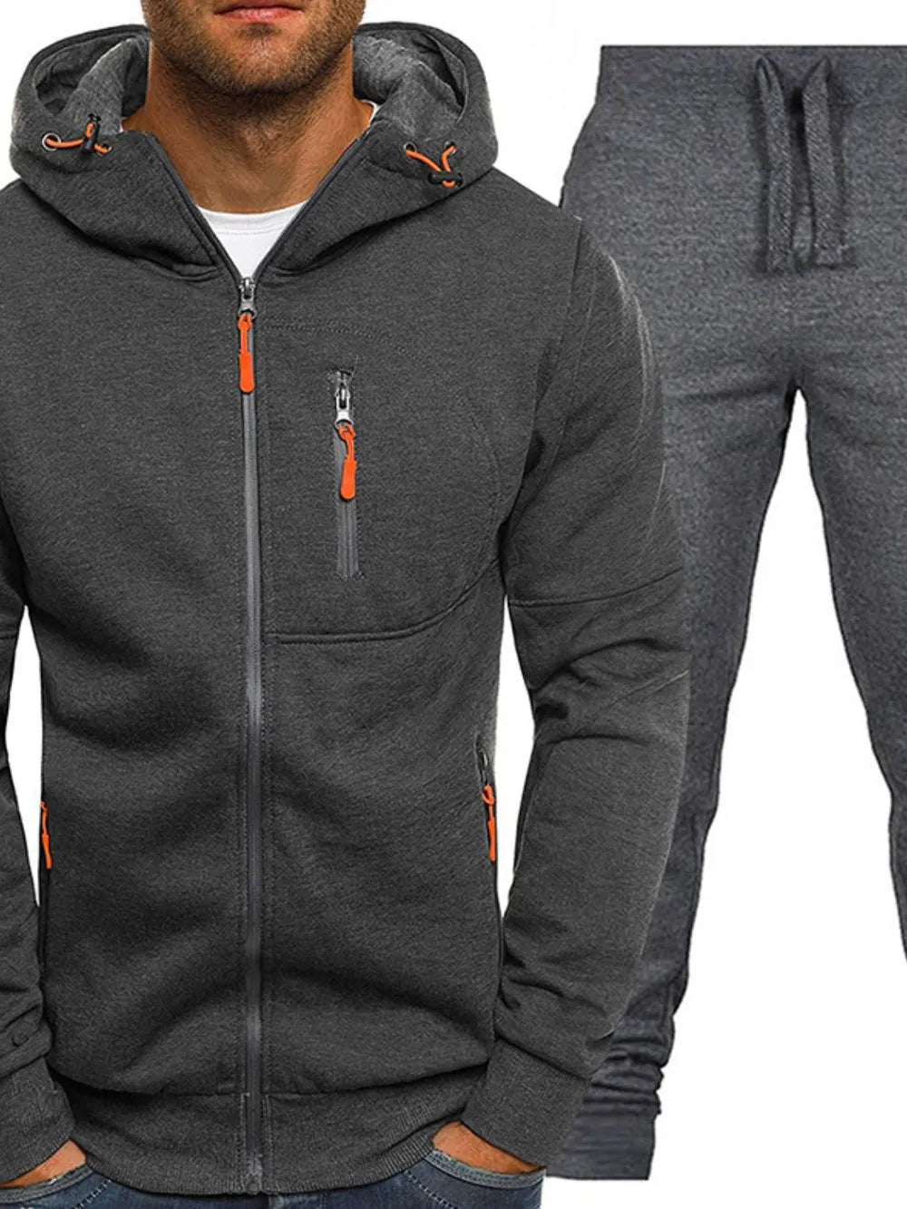 Dark gray tech tracksuit set with zip-up hoodie and drawstring pants, featuring orange zipper accents.