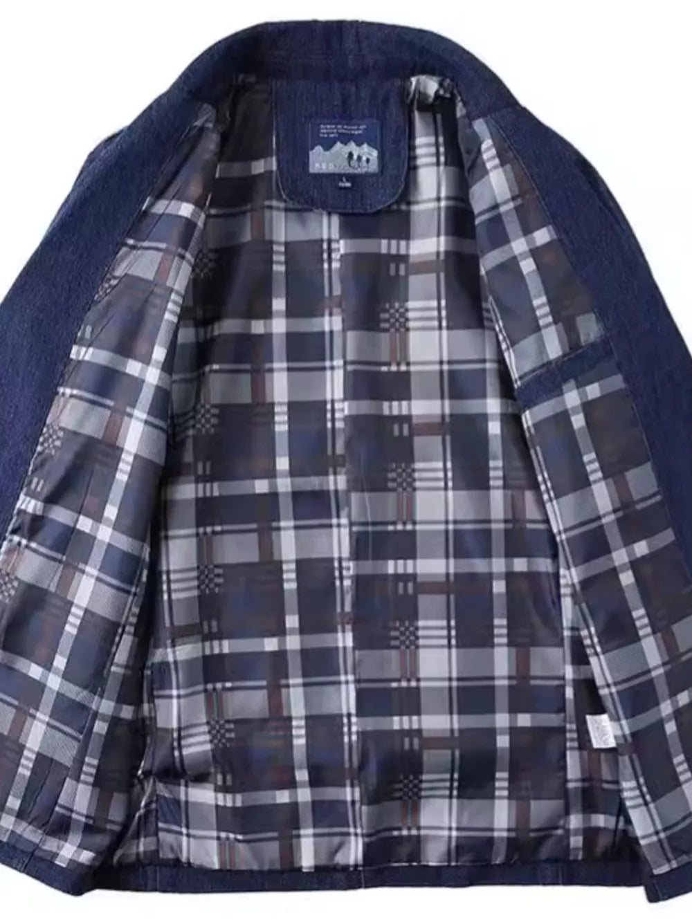 Dark blue denim blazer with plaid lining and notched lapels.