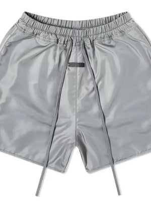 Nylon drawstring shorts in Dark Gray with a curved hem detail and elastic waistband.