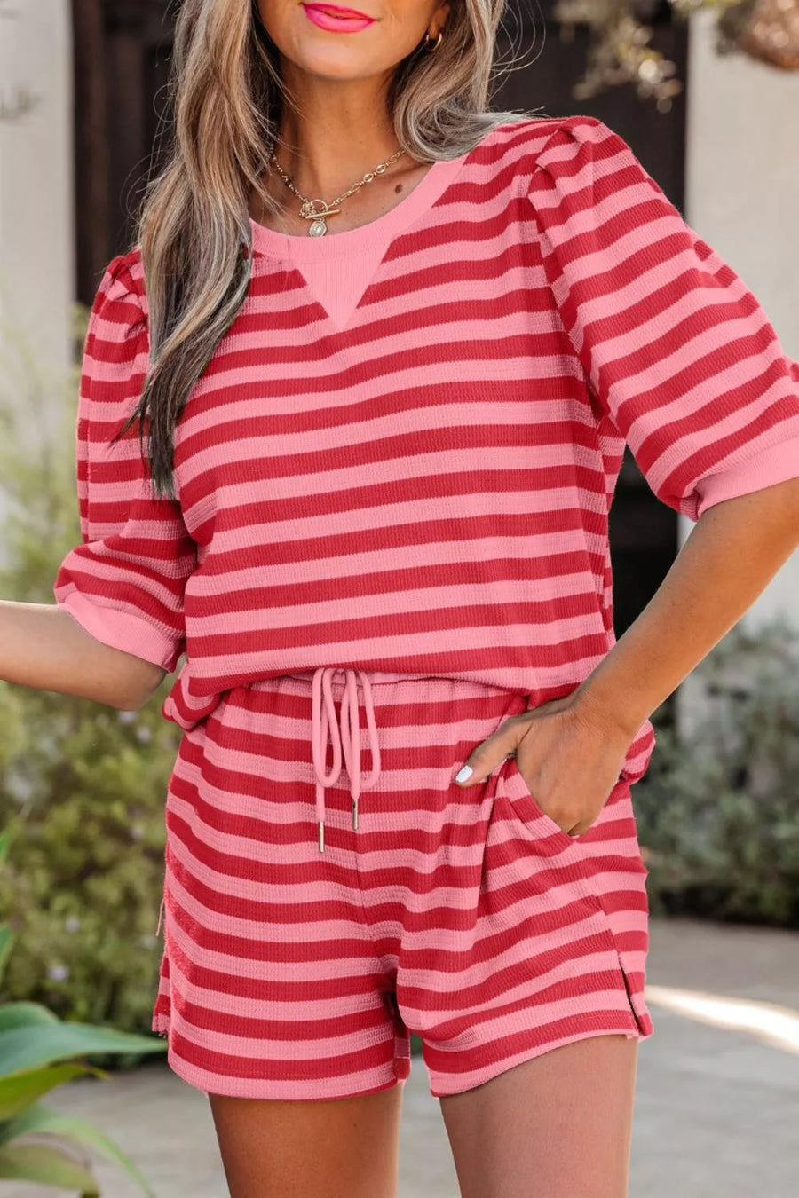 Striped two-piece set with puffed sleeve top and drawstring shorts in strawberry pink.