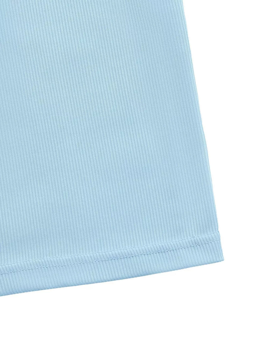 Light blue ribbed maxi dress with a subtle texture and hem detail.