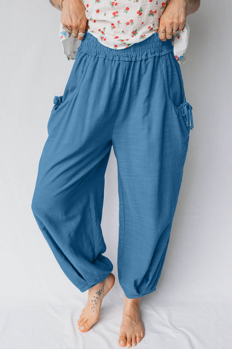 Blue cotton blend jogger pants with smocked waist and tie pockets