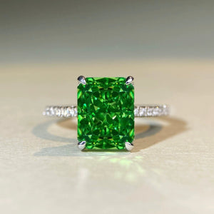 ring in emerald green featuring rectangular cut gemstone and geometric fit