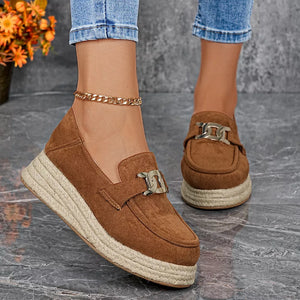Brown round toe platform loafers with chain detail and espadrille sole.