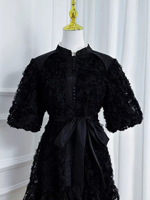 Black floral puff sleeve dress with button-down front and sash tie waist.