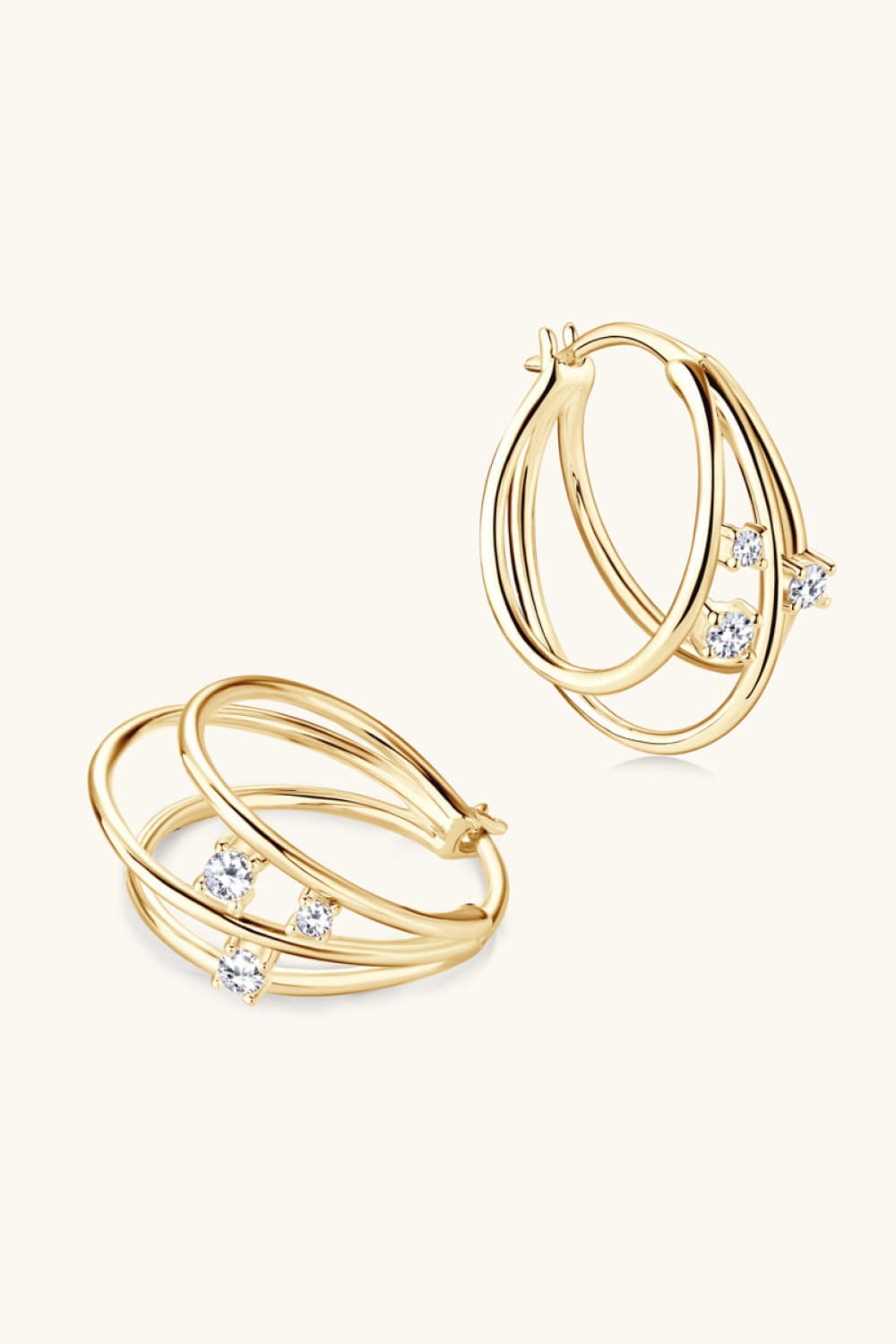 Gold hoop earrings with layered design and cubic zirconia accents.