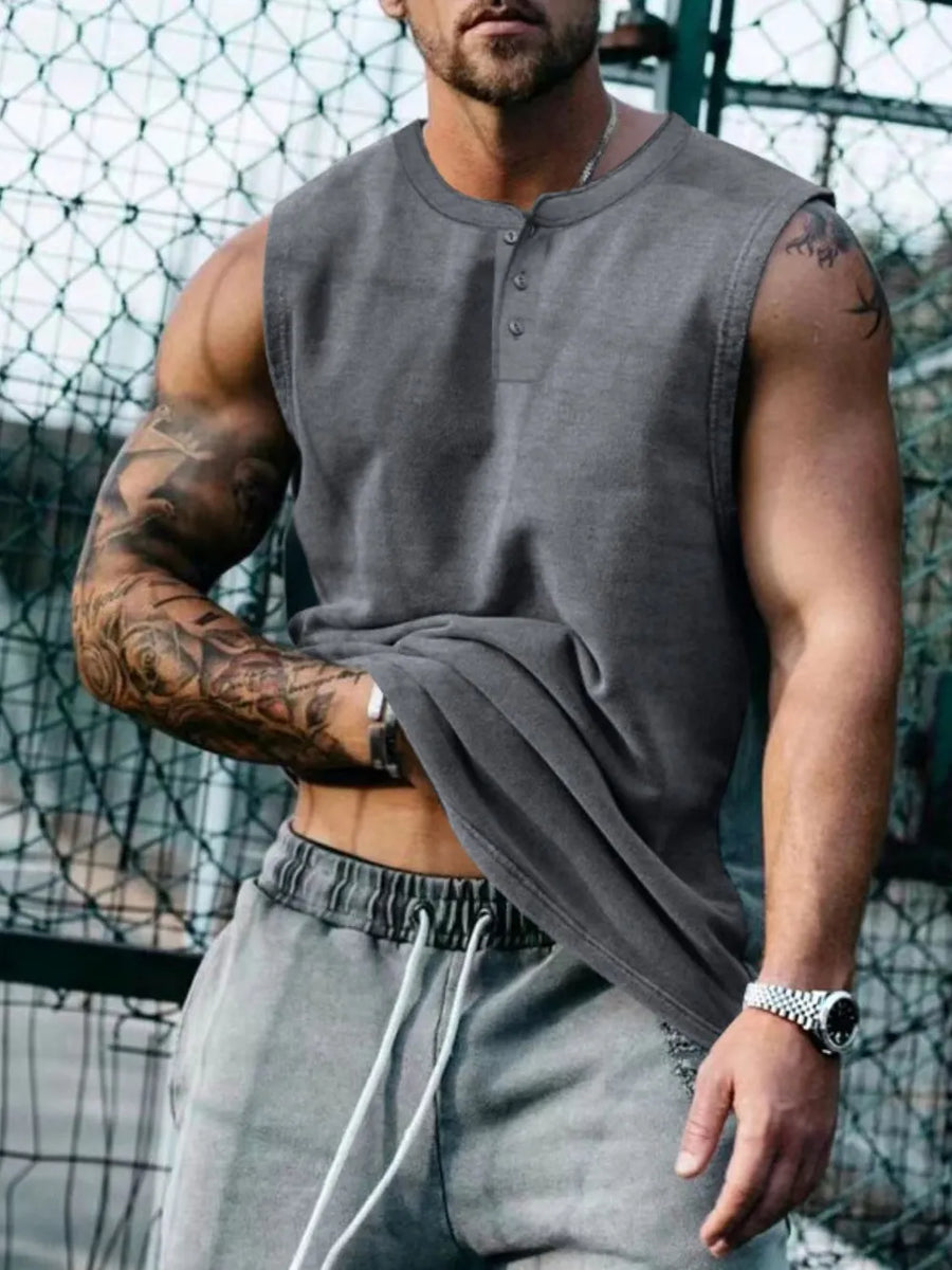 Sleeveless gray henley tank top with button detail, showing a man's muscular arms and torso.