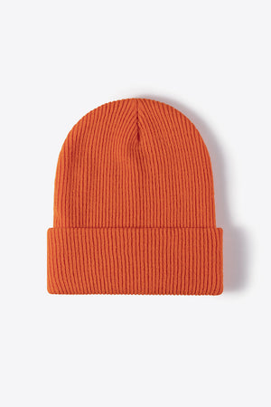 Ribbed knit beanie in tangerine acrylic with a cuffed hem.