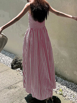 Pink striped maxi dress with smocked bodice and side slit.