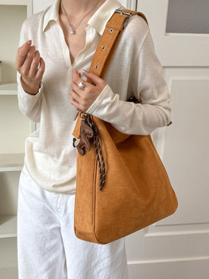 crossbody bag in camel featuring adjustable straps and slouchy fit