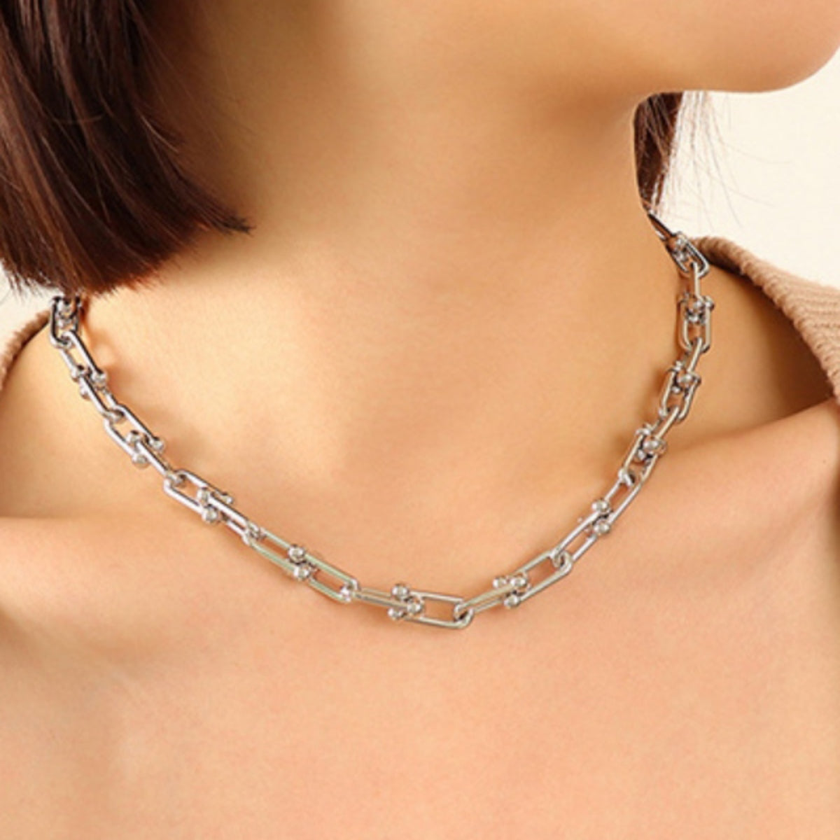 Silver chunky chain collar necklace with U-shaped links and small bead accents.
