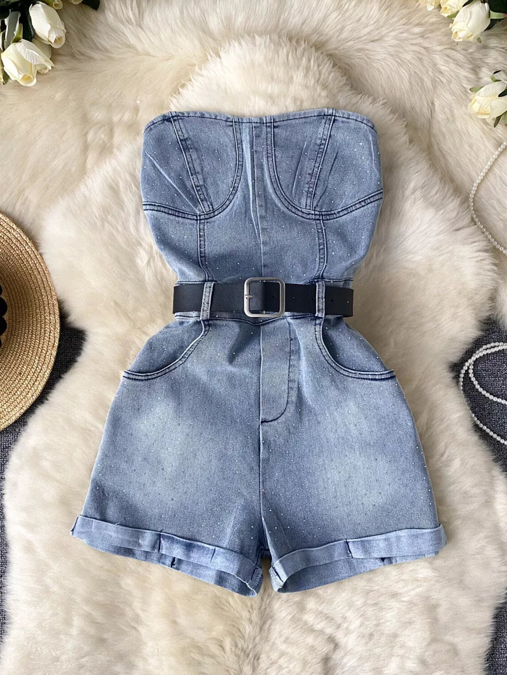 Blue denim strapless romper with rhinestone embellishments and black belt