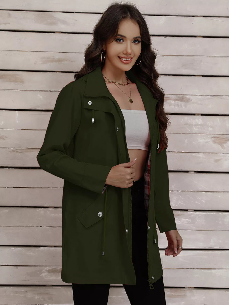 Military green drawstring trench coat with snap-down details and a plaid lining.