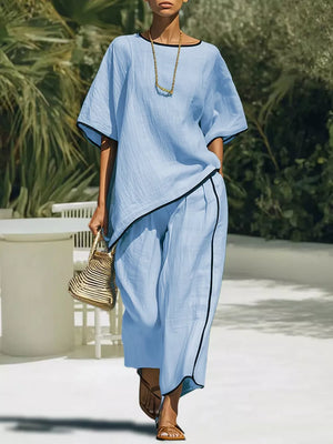 Sky blue two-piece set with contrast trim, cropped pants and asymmetrical top.