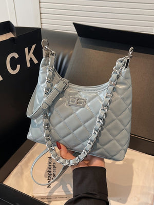 Quilted pu leather shoulder bag in blue with silver chain strap and buckle detail.
