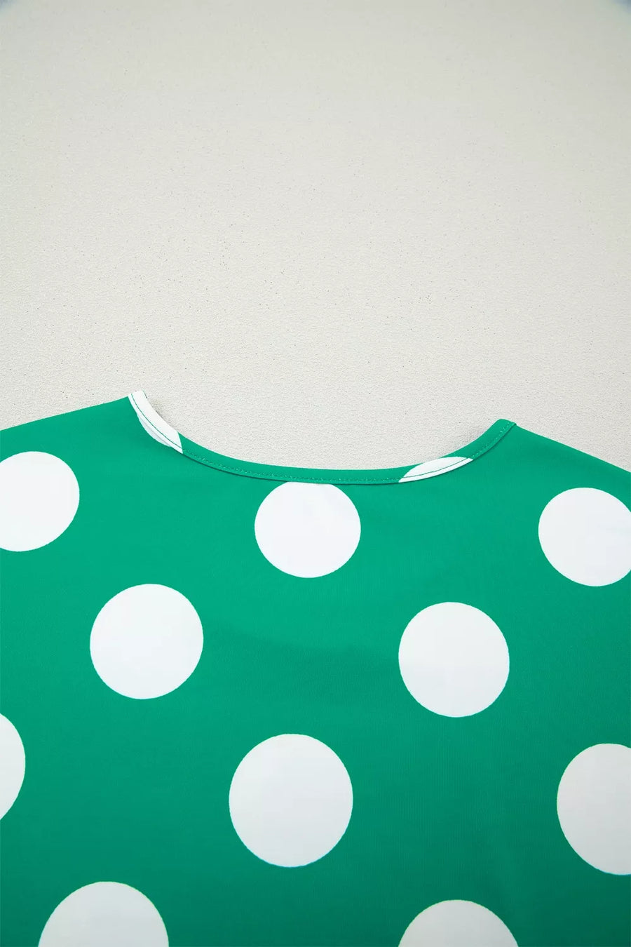 Green polka dot cropped tee with white polka dots and a crew neck.