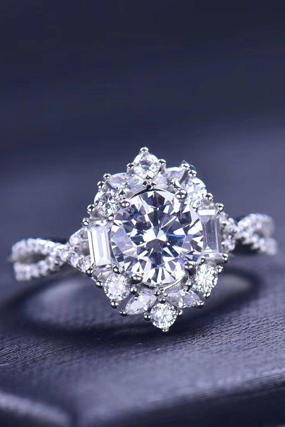 Silver floral halo twist ring with round and baguette cut stones