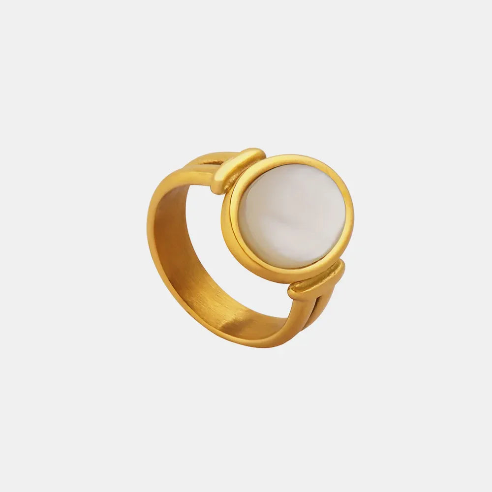 Gold oval signet ring with mother-of-pearl inlay and modern band detail.