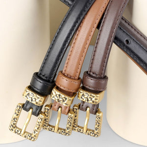 Ornate buckle cowhide leather belts in black, coffee brown, and brown with gold buckles.