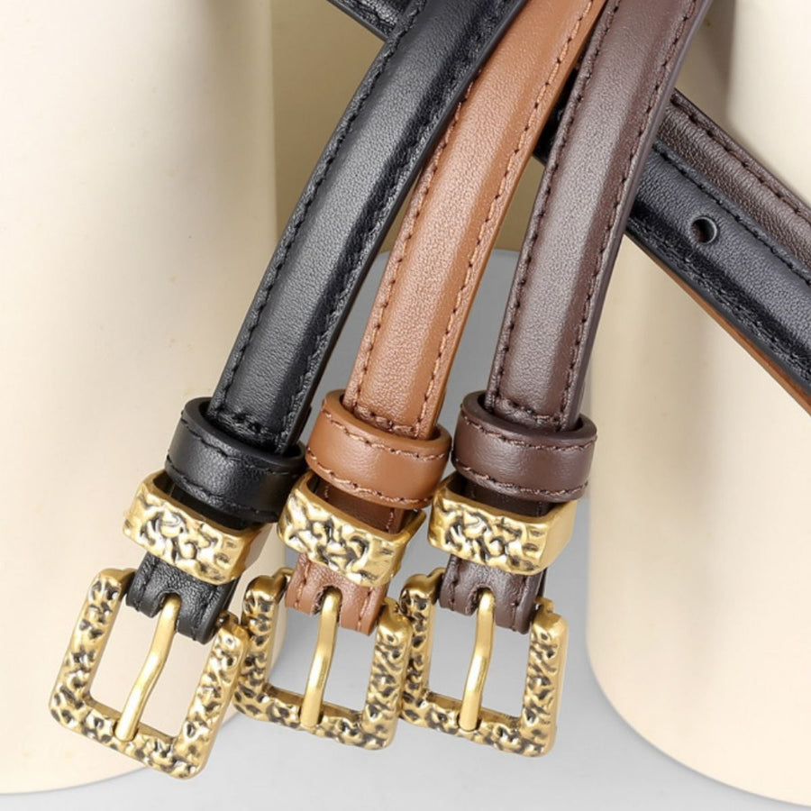 Ornate buckle cowhide leather belts in black, coffee brown, and brown with gold buckles.