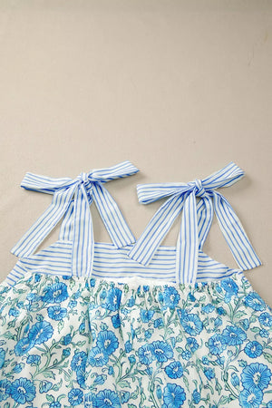 Botanical print mini dress with blue striped tie straps and a smocked waist.
