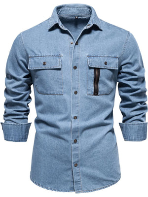 Light blue denim utility shirt with zip pocket and buttoned chest pockets.