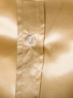 Men's yellow satin button-down shirt with a clear button detail.