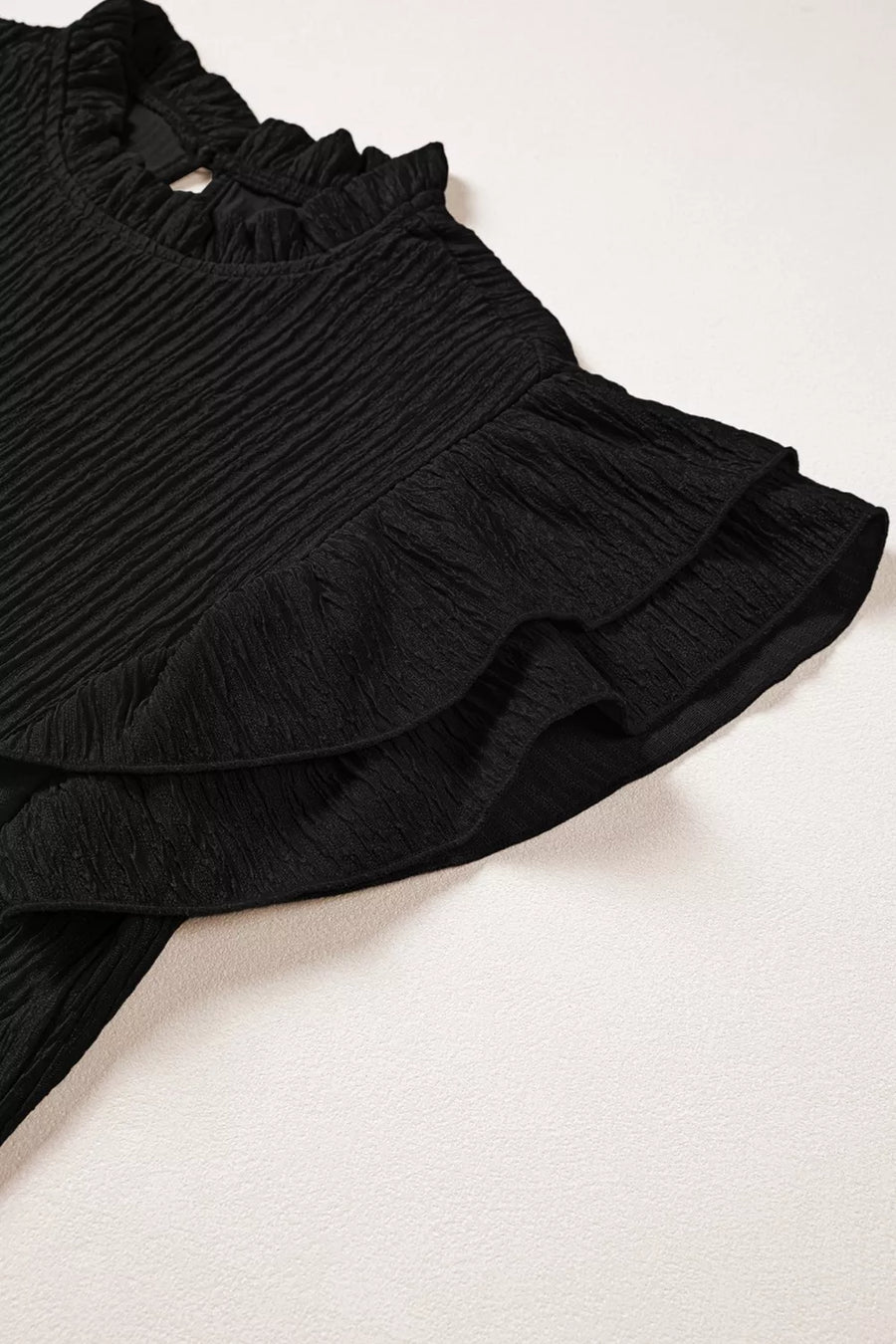 Black textured maternity shirt with frilled ruffle sleeves and neckline
