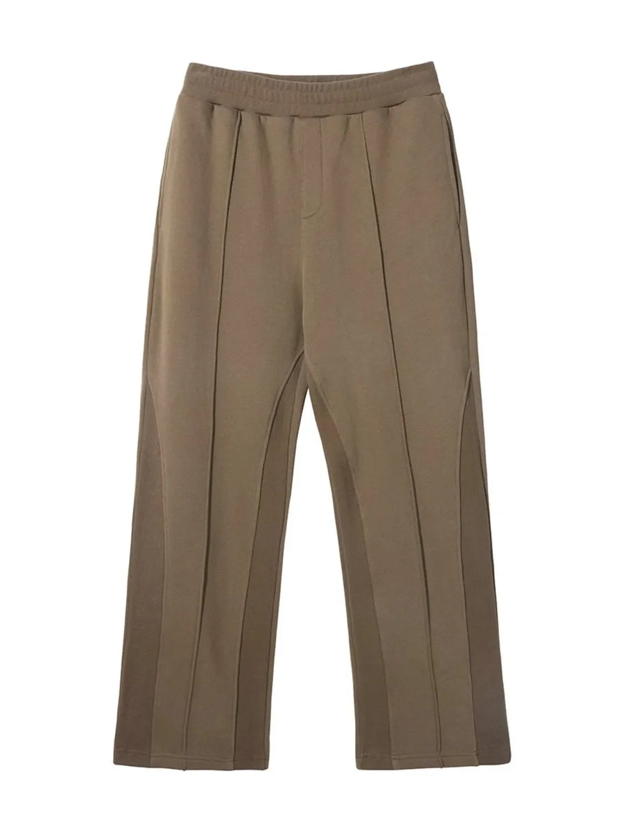 Taupe lounge trousers with vertical seam details and a relaxed fit.