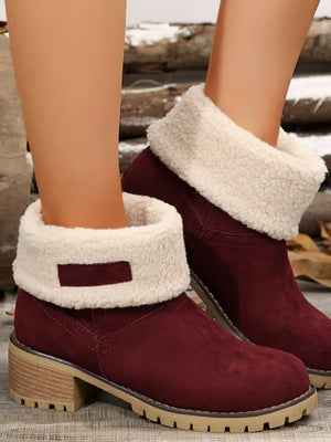 Burgundy suede ankle boots with sherpa trim and block heel.