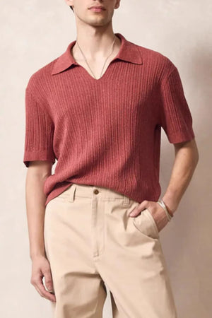 Textured ribbed knit polo shirt in orange-red with Johnny collar and short sleeves.
