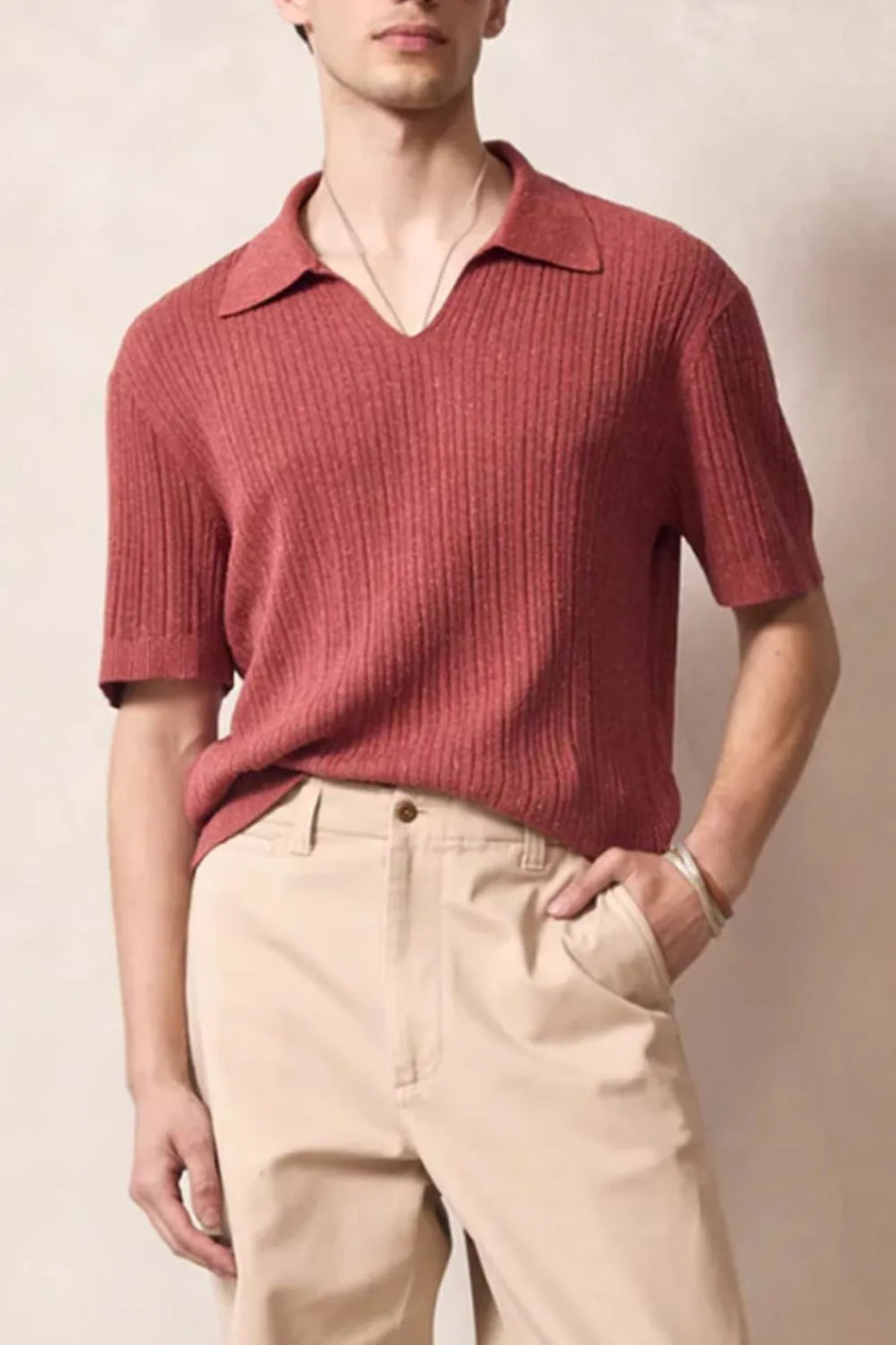 Textured ribbed knit polo shirt in orange-red with Johnny collar and short sleeves.