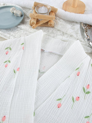 White cotton robe with delicate pink floral print and green leaves