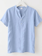 Light blue relaxed-fit men's short sleeve overshirt with band collar and button detail.