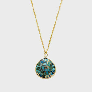 Gold chain necklace with a teardrop turquoise stone pendant with gold flecks.