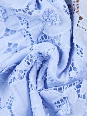 Sky blue lace midi dress with intricate floral details and cutouts.