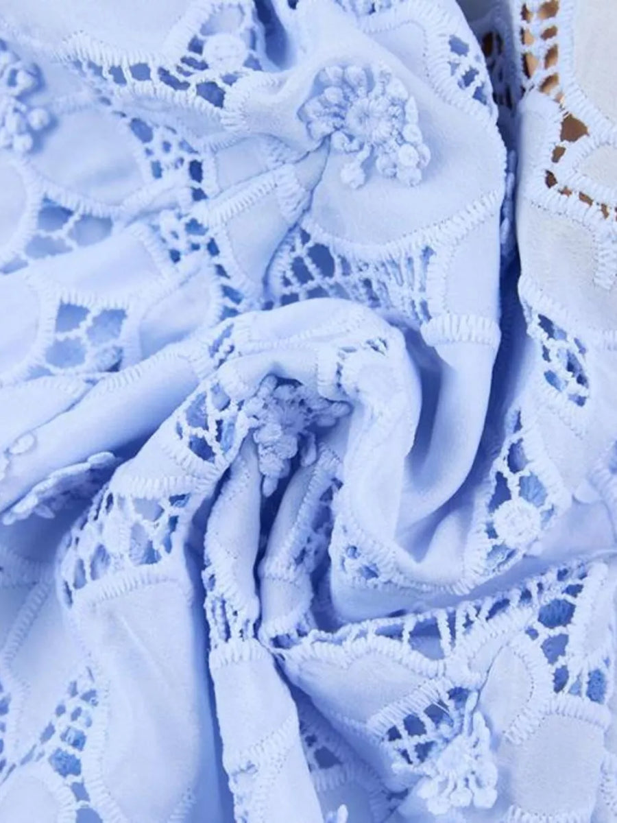 Sky blue lace midi dress with intricate floral details and cutouts.
