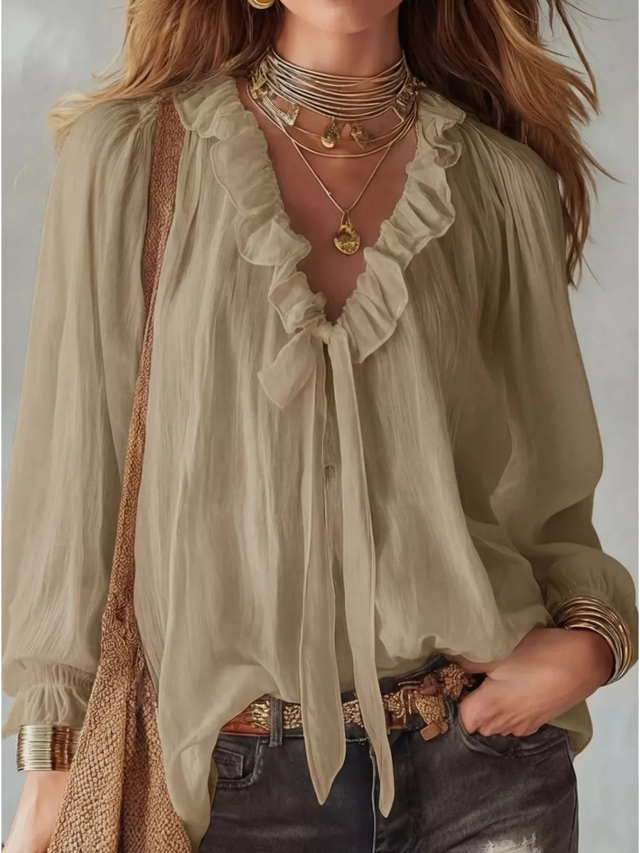 Khaki frilled tie-front shirt with ruffled neckline and long sleeves.