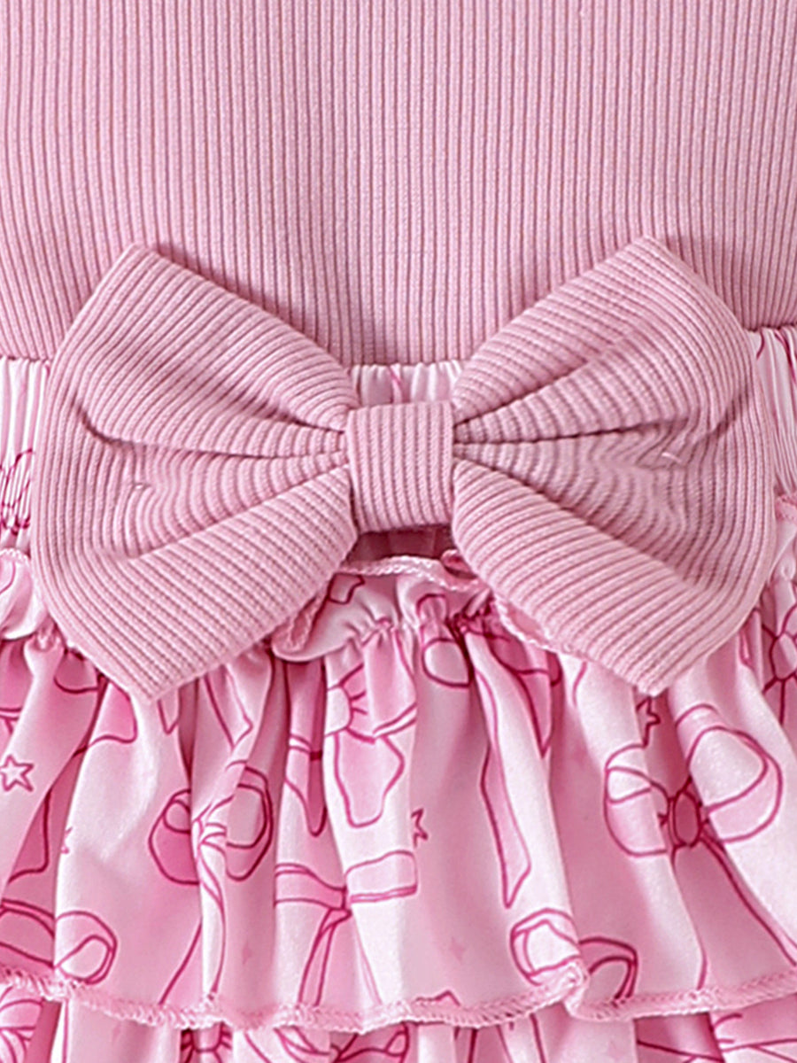 Pink ribbed cotton baby bodysuit with bowknot detail and ruffled skort with bow print