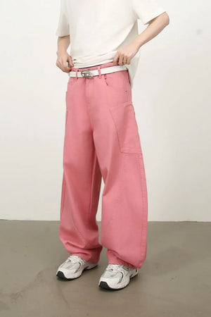 Dusty pink wide leg trousers with sculpted pocket details and a white belt.