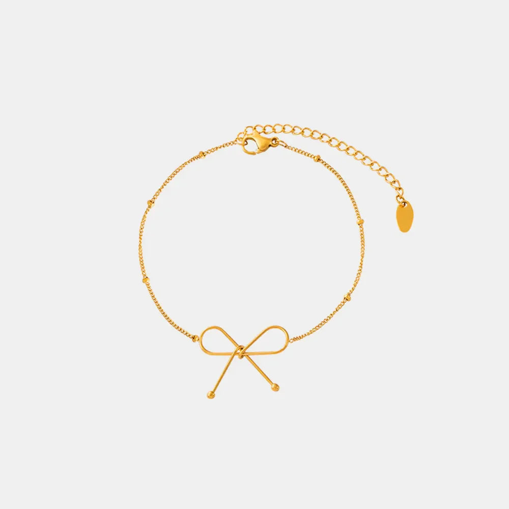 Gold delicate bow silhouette bracelet with beaded chain and adjustable clasp