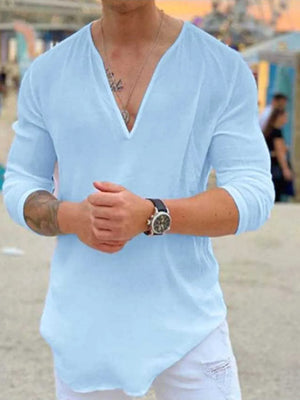 Pastel blue linen relaxed fit top with deep V-neck and long sleeves.