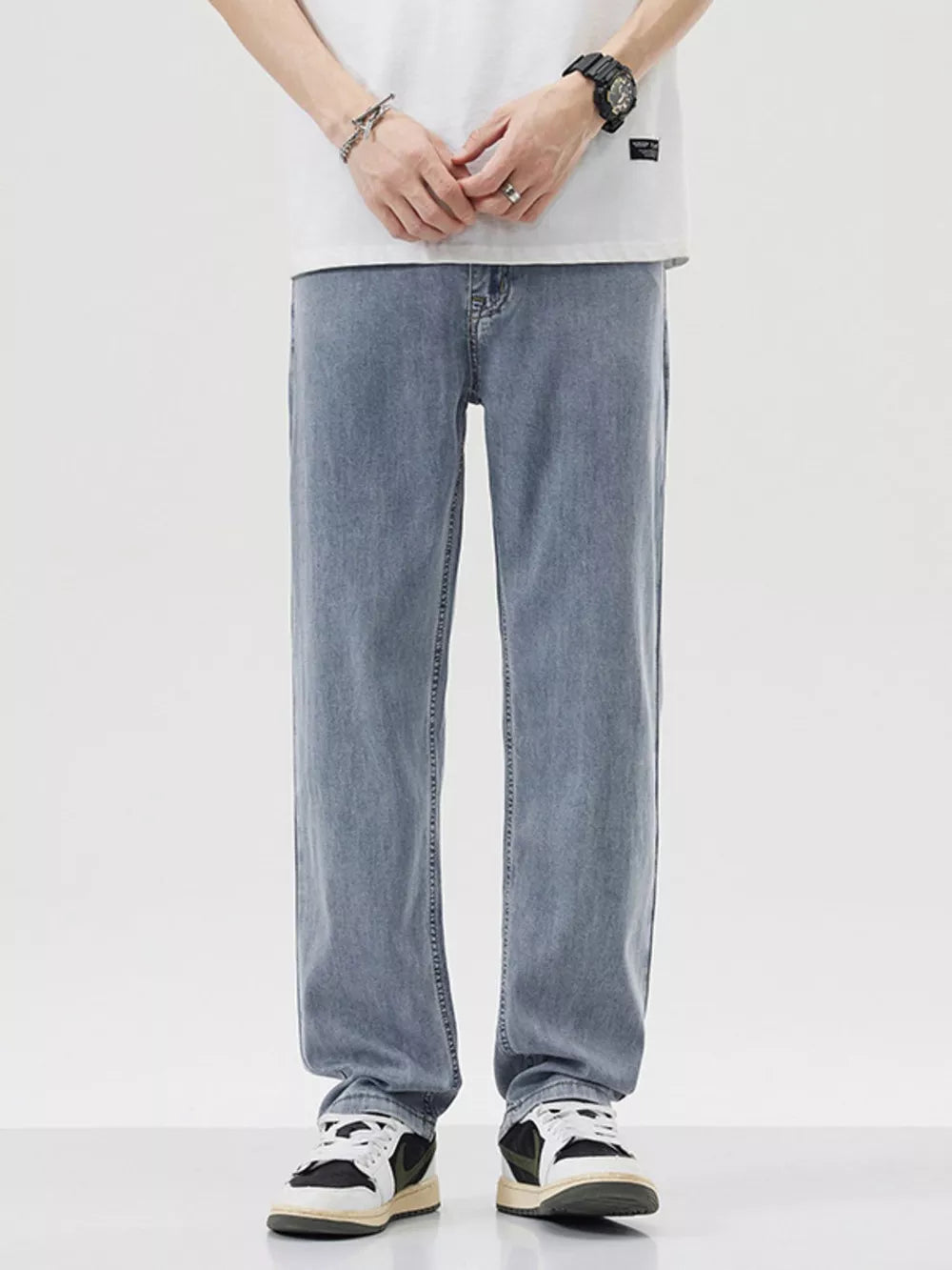 Relaxed fit wide-leg denim trousers in light blue, styled casually.