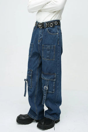 Medium wash denim cargo pants with buckle pockets and straps.