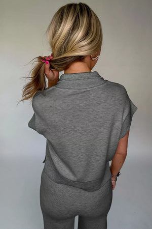 Chic dark gray half-zip polo and wide-leg set with short sleeves.