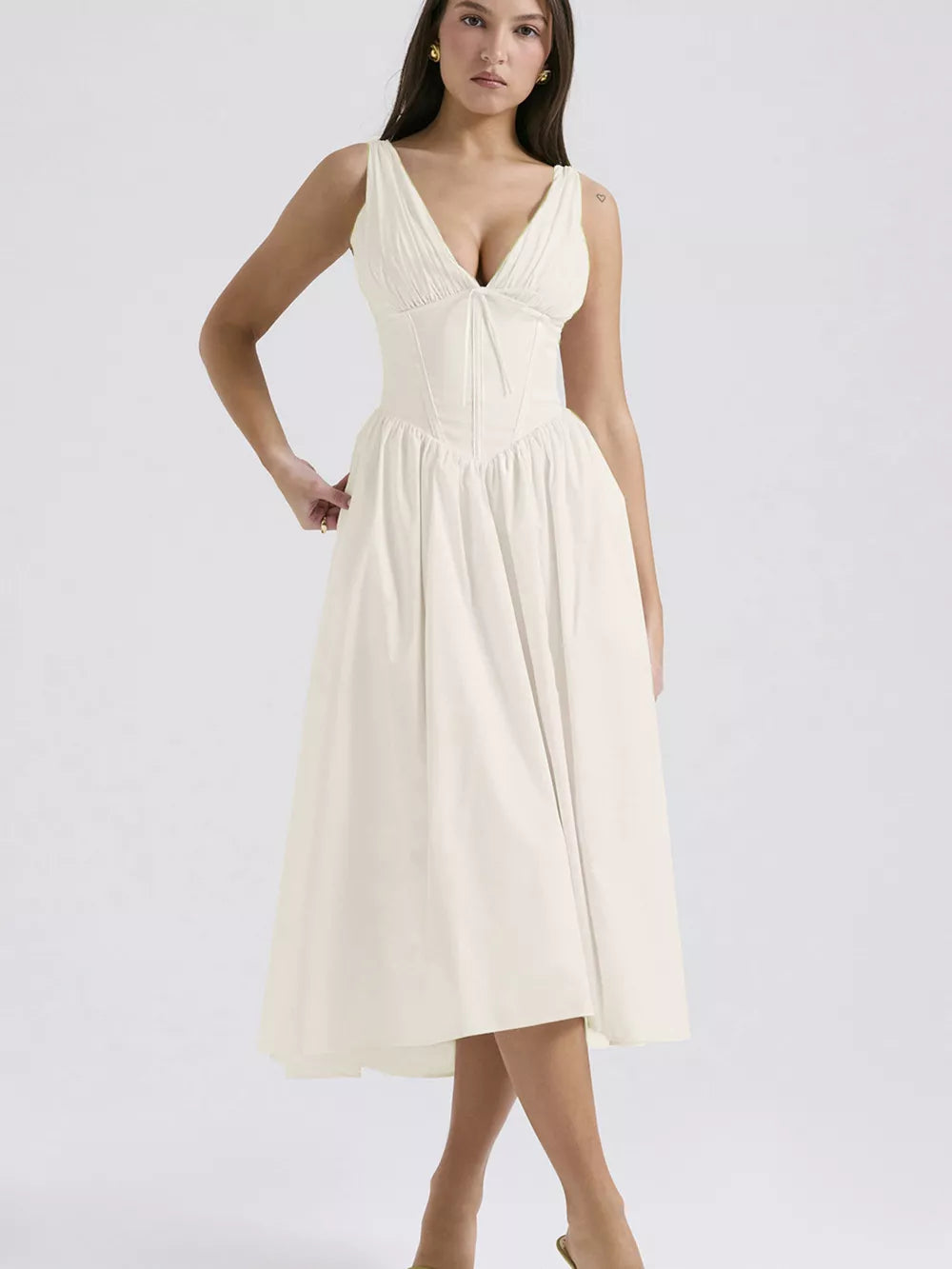 Cream v-neck midi dress with ruched bodice and full a-line skirt.