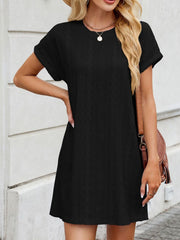 Black eyelet mini dress with crew neck and short sleeves, diamond pattern, A-line cut.