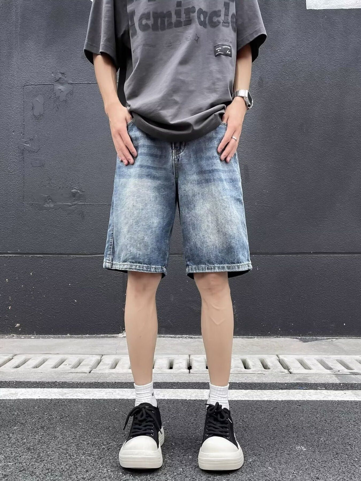 Blue relaxed fit denim shorts with a vintage wash and distressed details.